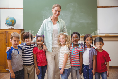 Cute pupils smiling at camera in classroom