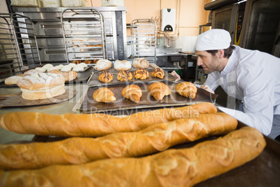 Baker checking freshly baked bread