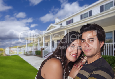 Happy Hispanic Young Couple in Front of Their New Home