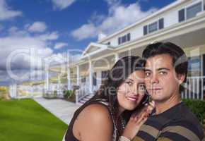 Happy Hispanic Young Couple in Front of Their New Home