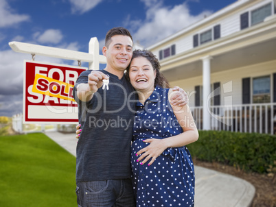 Hispanic Couple with Keys In Front of Home and Sign