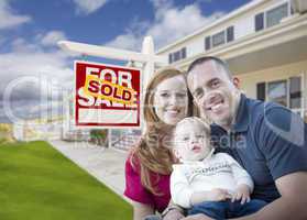 Young Military Family in Front of Sold Sign and House