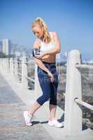 Fit blonde listening to music on the pier
