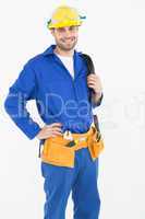 Happy construction worker standing with hand on hip