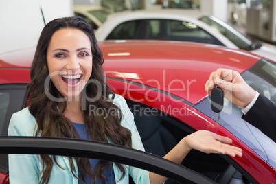 Excited woman receiving car key