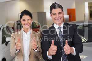 Business team giving thumbs up