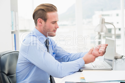 Businessman suffering from wrist pain