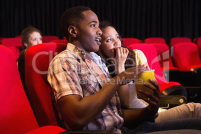 Young couple watching a film