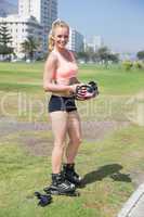 Fit blonde getting ready to roller blade