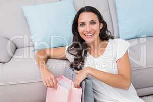 Pretty brunette opening shopping bag