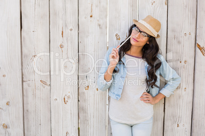 Pretty brunette thinking and smiling