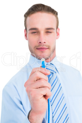 Smiling businessman in shirt holding a cable