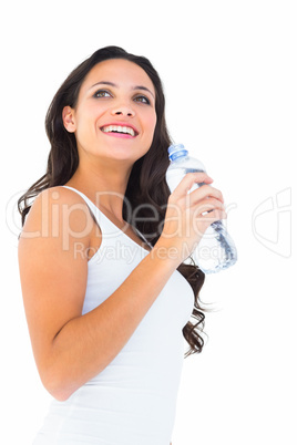 Pretty brunette drinking bottle of water