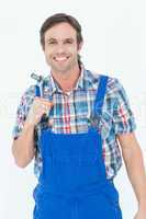 Confident plumber holding tool over white background