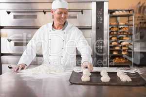 Baker putting dough on baking tray