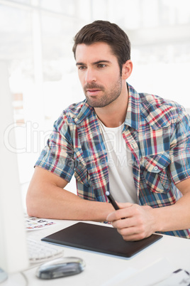 Focused designer using computer and digitizer