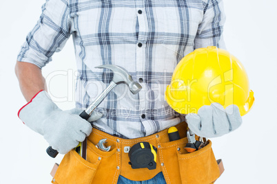 Handyman holding hammer and hard hat