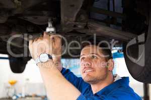 Mechanic examining under the car