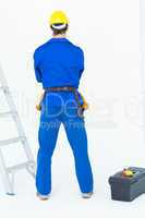 Electrician standing against white background