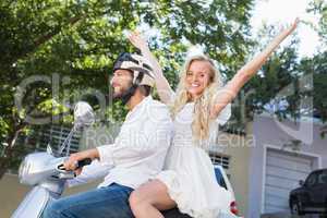 Attractive couple riding a scooter