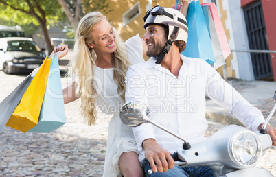 Attractive couple riding a scooter