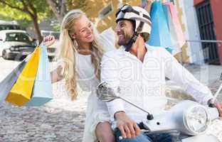 Attractive couple riding a scooter