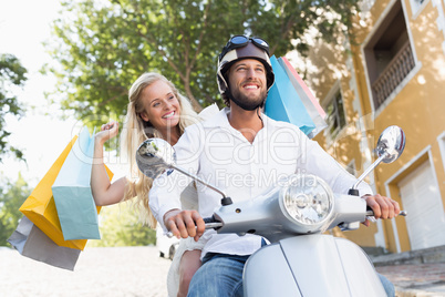 Attractive couple riding a scooter