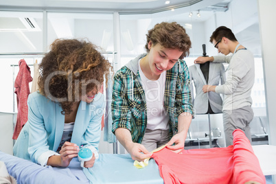 Students working together with a fabric