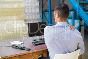 Warehouse manager working on computer