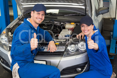 Team of mechanics smiling at camera