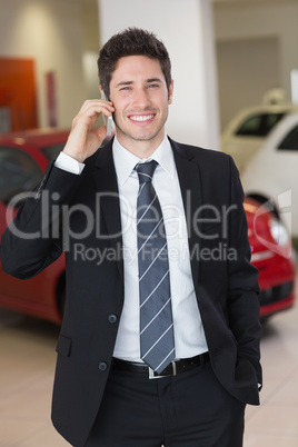 Smiling businessman calling with his mobile phone