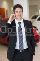 Smiling businessman calling with his mobile phone