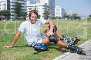 Fit man getting ready to roller blade