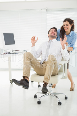 Smiling partners playing together with swivel chair