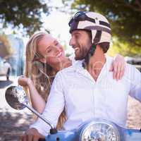 Cute couple riding a scooter