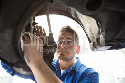 Focused mechanic adjusting the wheel