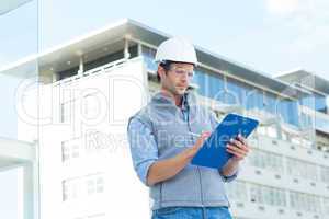 Architect writing on clipboard