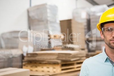 Close up of worker wearing hard hat in warehouse