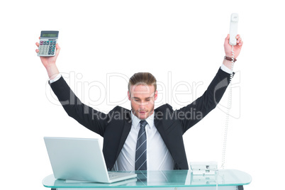 Businessman cheering holding calculator and telephone