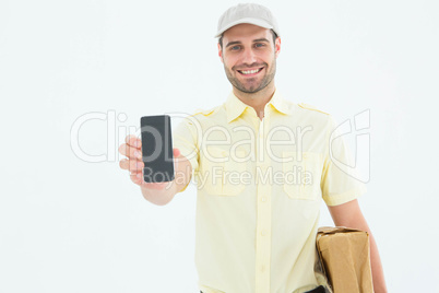 Handsome delivery man showing mobile phone