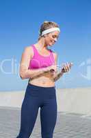 Fit blonde standing on the promenade