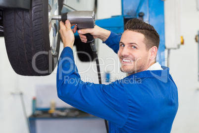 Mechanic adjusting the tire wheel