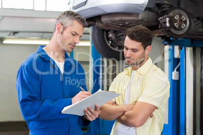 Customer listening to his mechanic