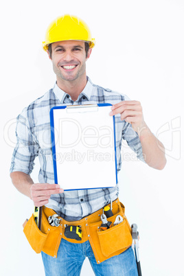 Confident carpenter holding clip board