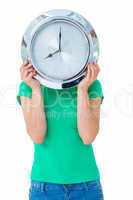 Woman holding clock in front of her face