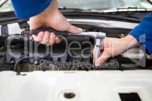 Close up of mechanic working on car