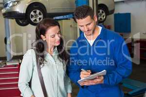 Mechanic and customer talking together