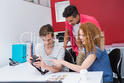 Smiling students working with camera together Smiling students working with camera together