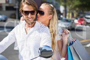 Attractive couple riding a scooter