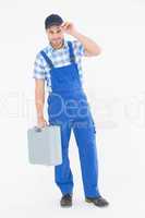 Confident male repairman carrying toolbox